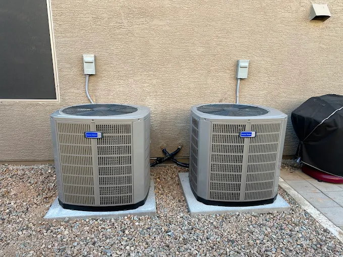 A matched pair of American Standard condensing units installed on level pads at a Maricopa home