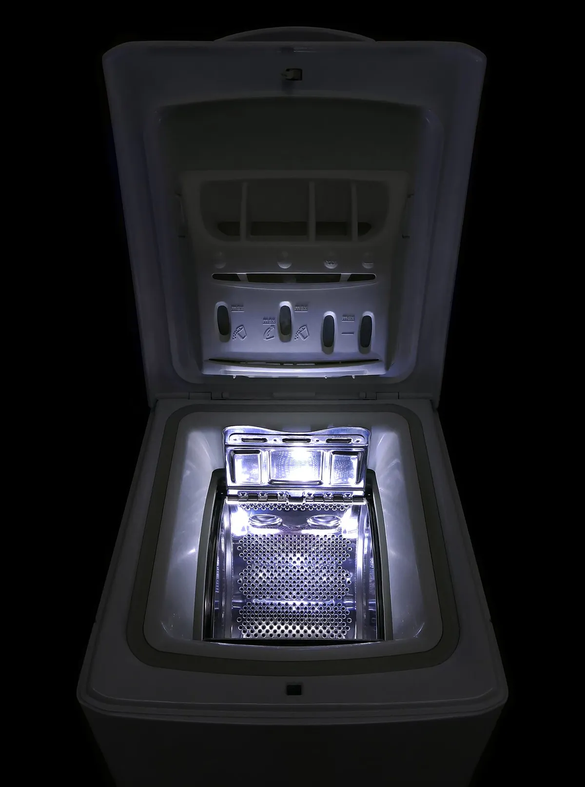 Top-loading washing machine with the lid open and the stainless steel drum lit from inside